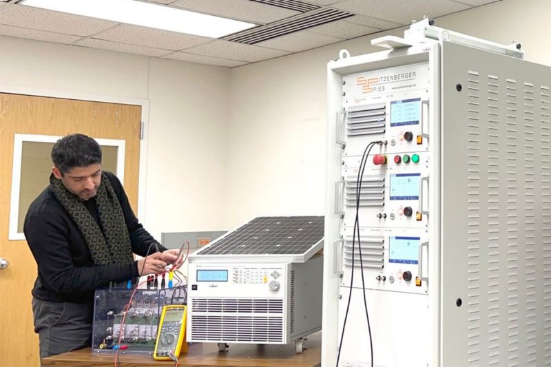 Students works on electric grid components
