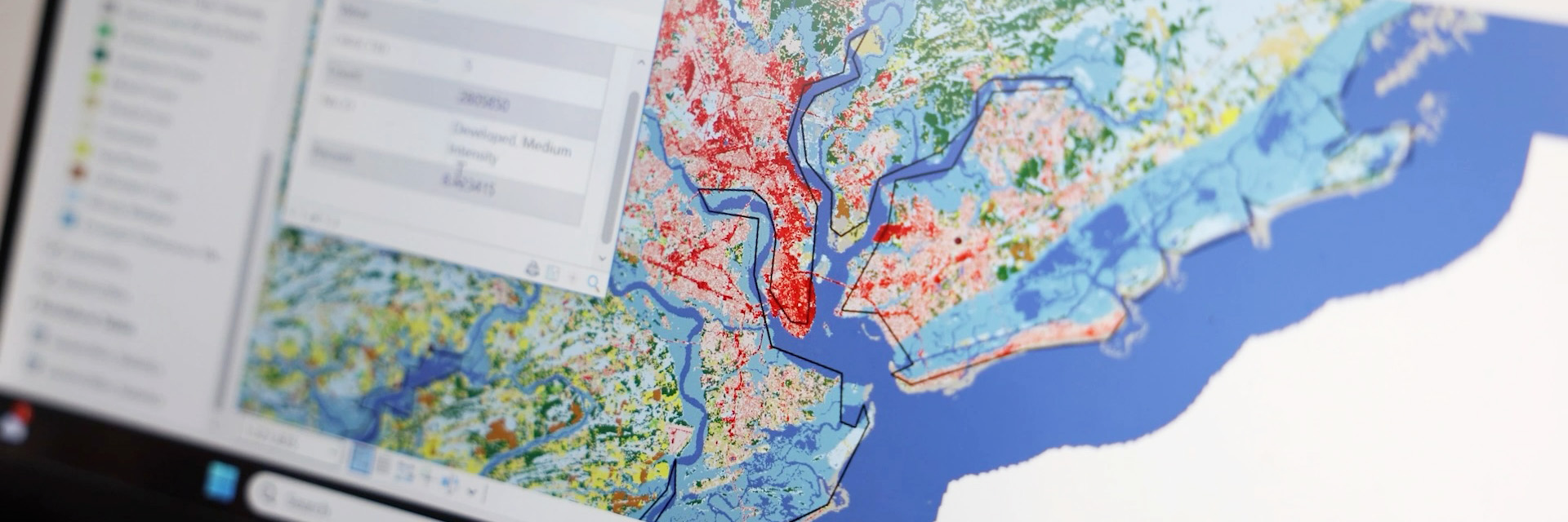 A computer screen showing colored points on a map of a coastal water system