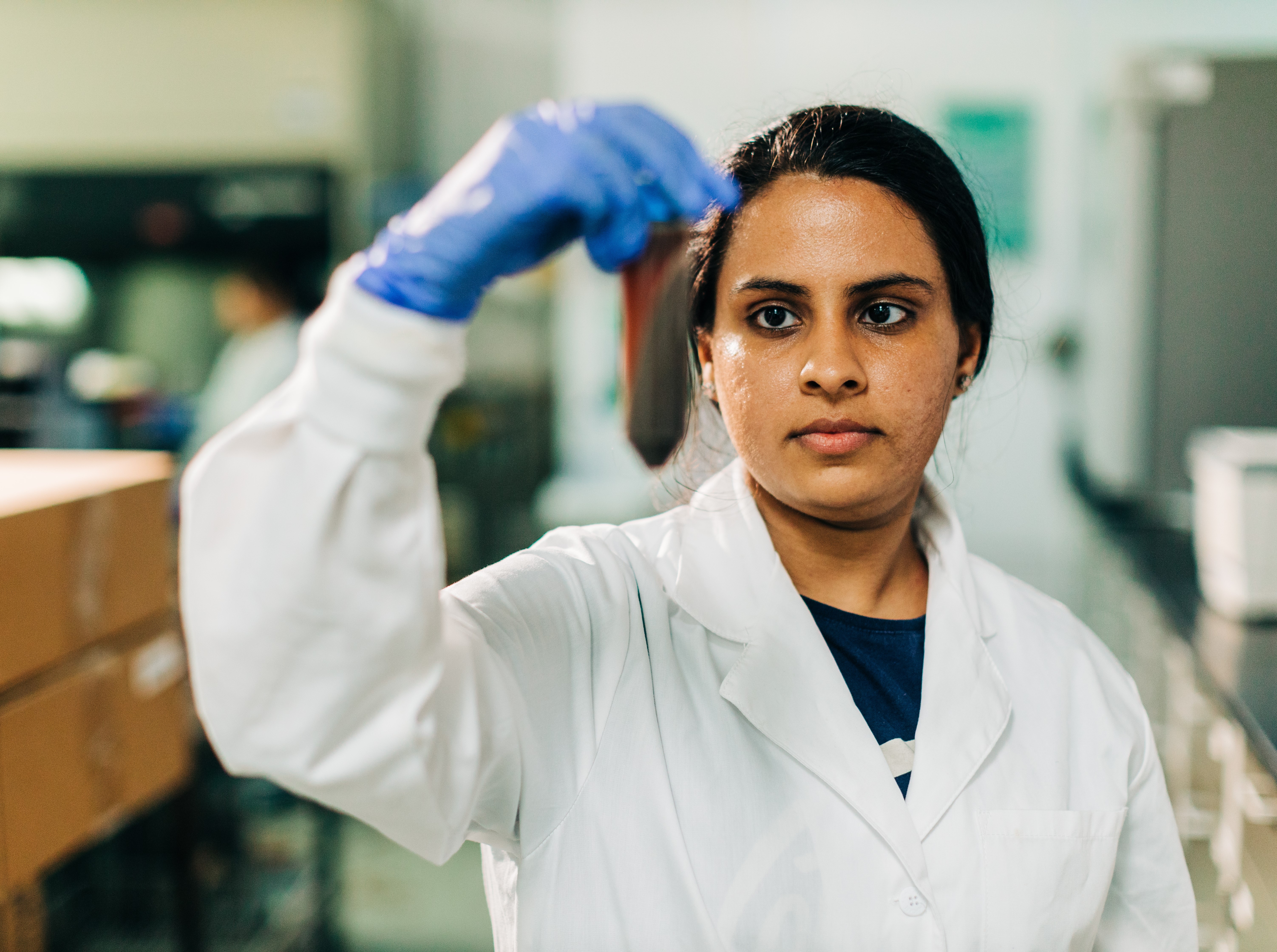 A student in the lab holding up a test tube