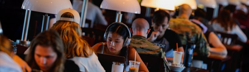 Students working on their computers on Torgersen Bridge. 